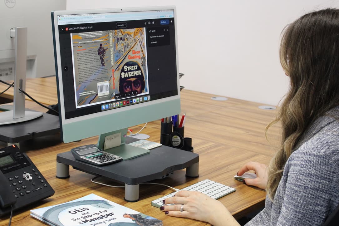 A designer reviewing a book cover on screen