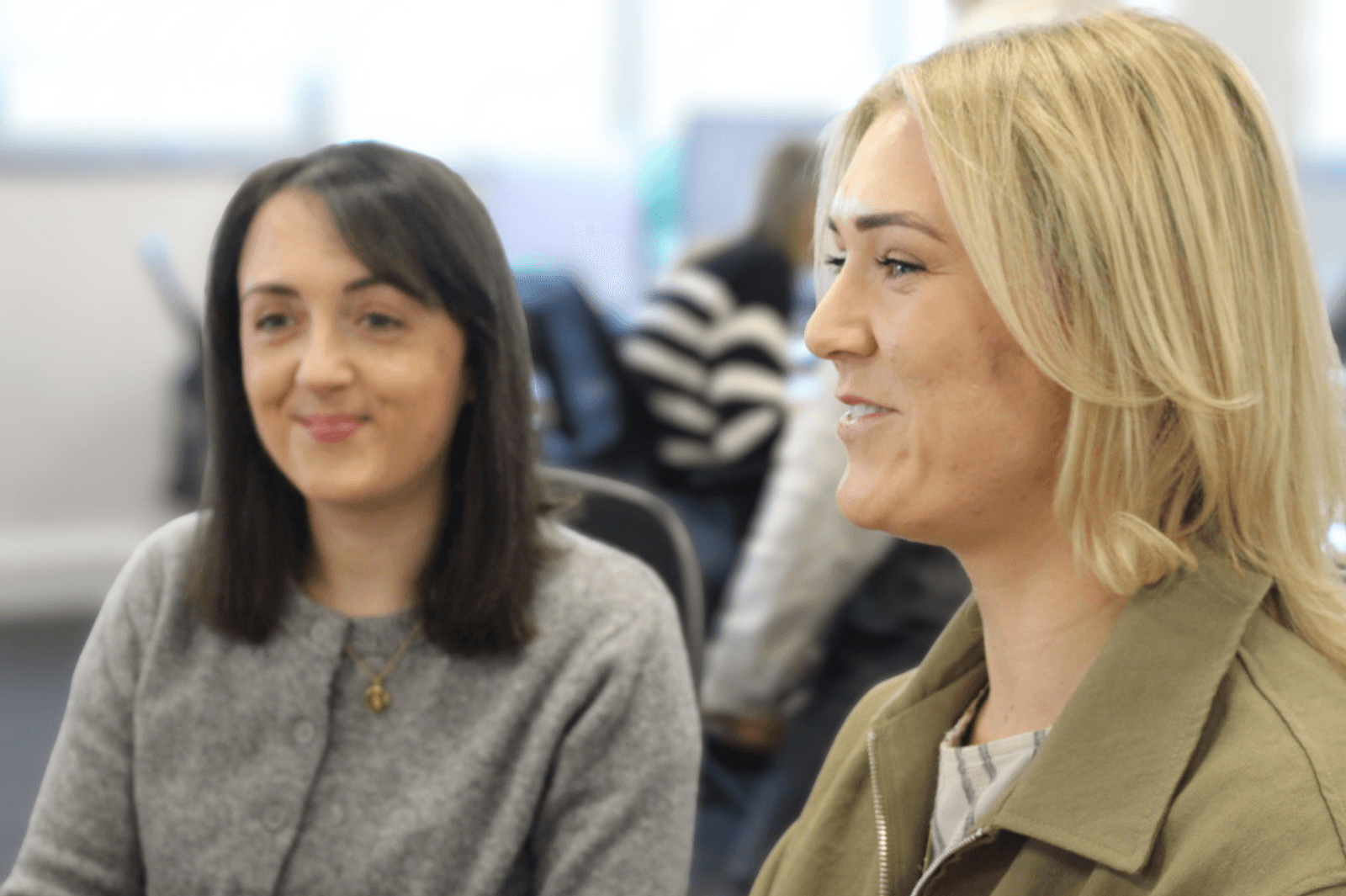 Two members of the Libero team smiling in the office
